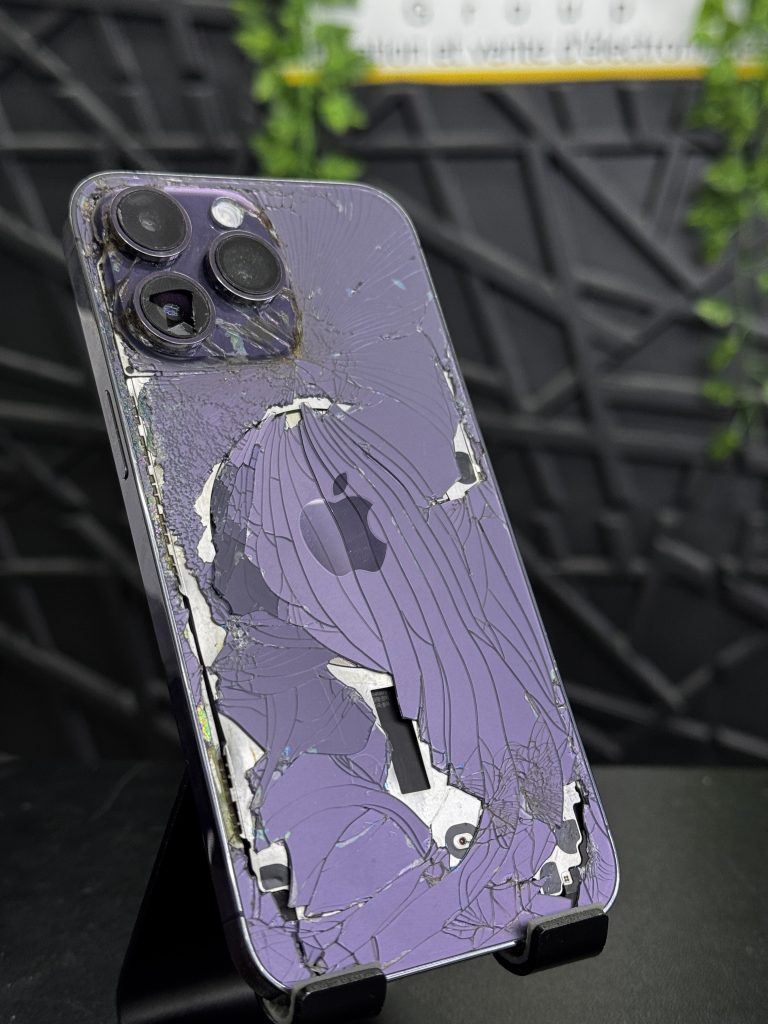 Purple iPhone with damaged rear glass before WBG repair